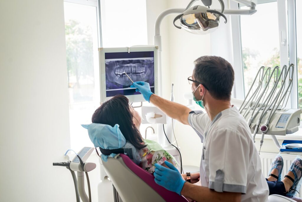 dentist showing a patient x-rays